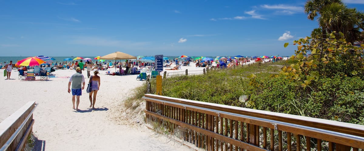 Fort Myers Beach showing a beach as well as a small group of people