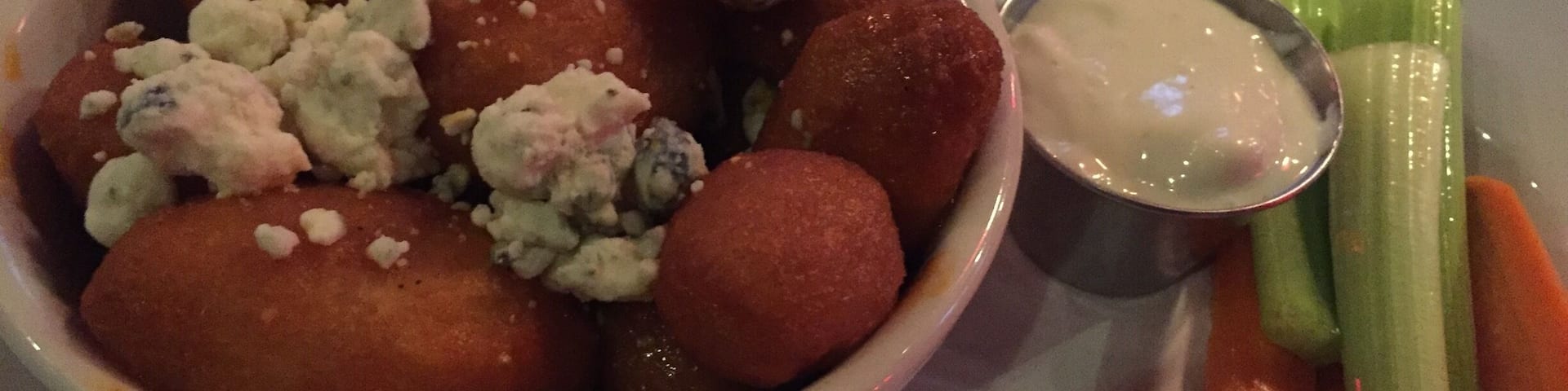 Yummy potatoes with hot sauce and blue cheese.