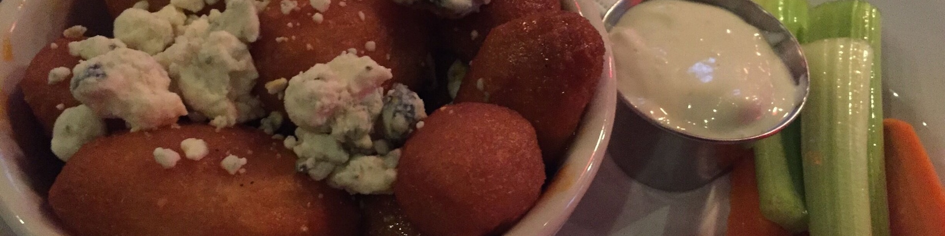 Yummy potatoes with hot sauce and blue cheese.