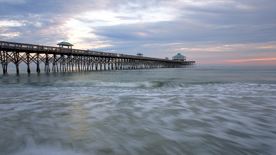 Folly Beach which includes a bridge, a sunset and a beach