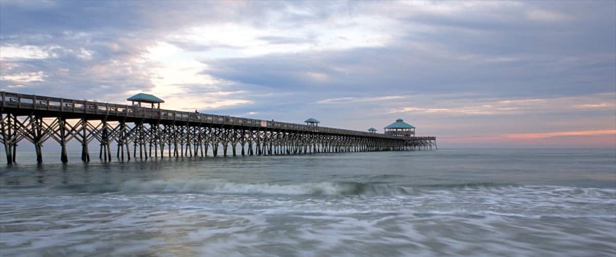 Folly Beach showing a beach, a sunset and a bridge