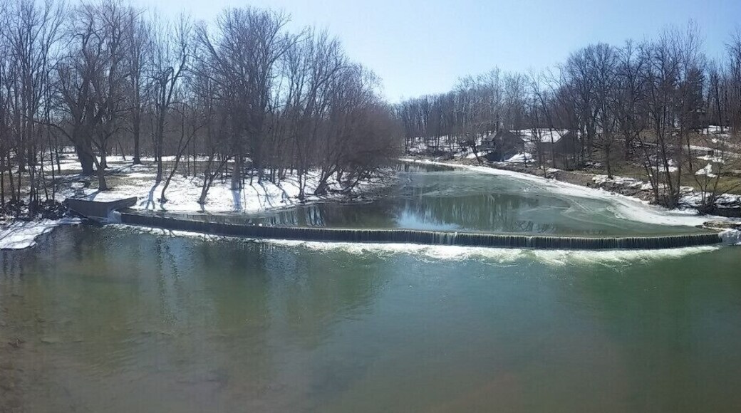 A look upriver from the bridge at the dam and mill on the Sandusky River. The three story flour mill was built in 1861 and is now owned and maintained by the Ohio Historical Society.