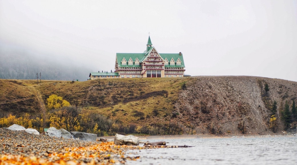 Waterton lakes national park lakeshore in autumn foliage season under cloudy sky, landmarks, Canada