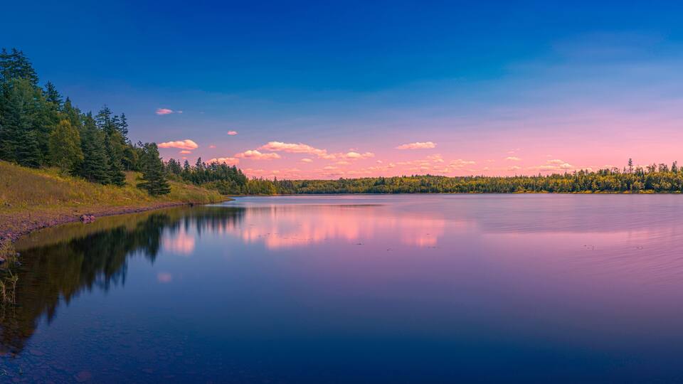 Colorful fantasy lake landscape and cloudscape over Town of Truro Reservoir at Victoria Park in Truro, Nova Scotia, Canada