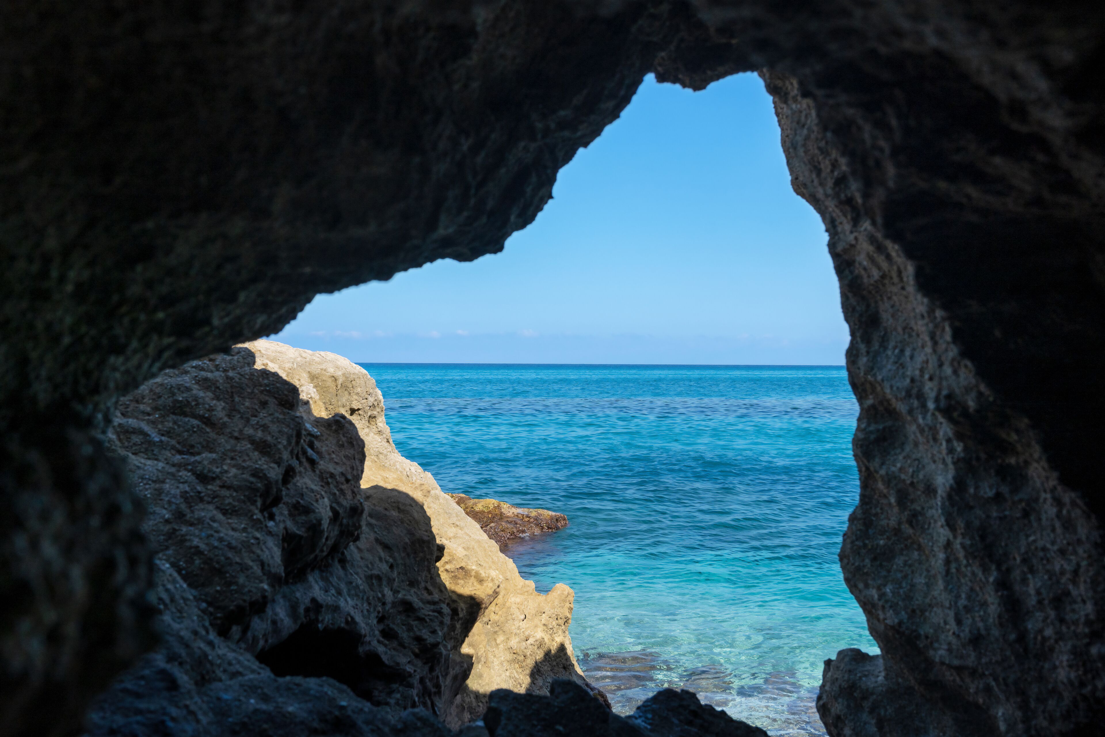 Grotta del Palombaro in cliff and transparent clear sea water. Tropea beach along Tyrrhenian sea, Coast of Gods, Calabria, southern Italy.
