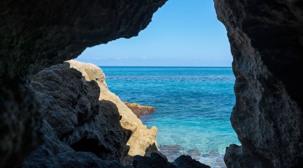 Grotta del Palombaro in cliff and transparent clear sea water. Tropea beach along Tyrrhenian sea, Coast of Gods, Calabria, southern Italy.