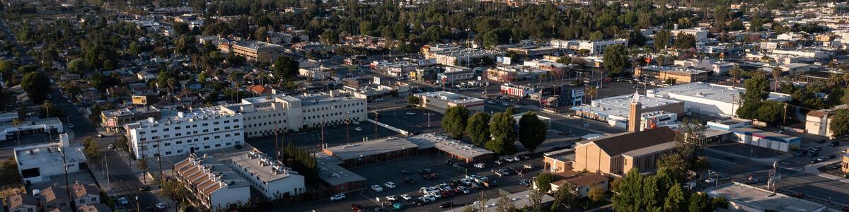 Los Angeles, California, USA - May 7, 2023: Sunset light shines on a church and urban core of downtown Canoga Park.