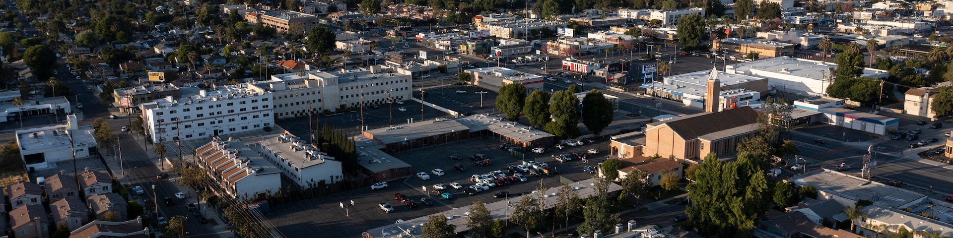 Los Angeles, California, USA - May 7, 2023: Sunset light shines on a church and urban core of downtown Canoga Park.