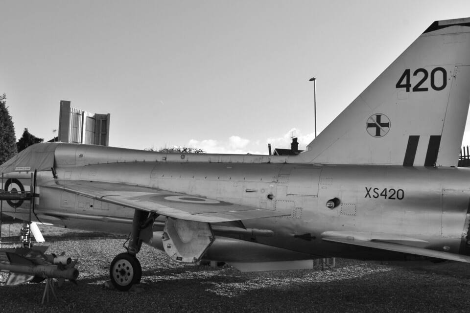 A military aircraft with the tail number 420 and marking XS420, parked outdoors.