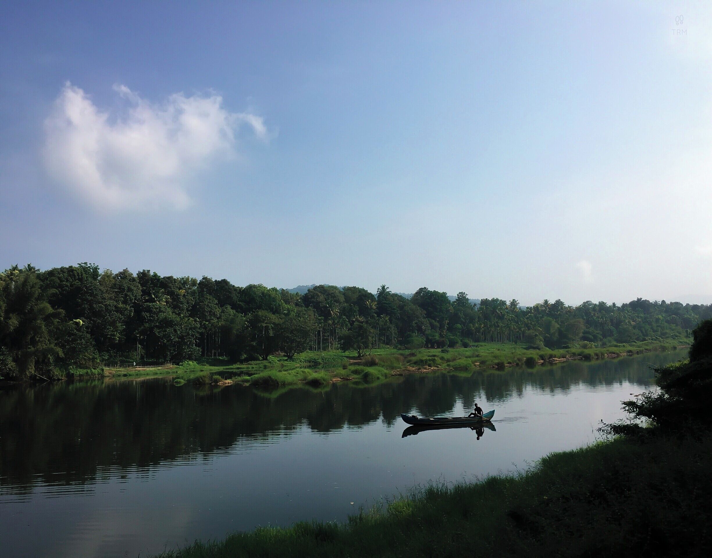 Kerala - God's own country. Indeed, it is! 
Lush green, bright sunlight, backwaters and houseboats, rivers and canoes, swaying palm trees and yummy food!
Kerala is a must visit if you love nature :)
 The lush green Malayatoor forest, the calm flow of the Periyar river, and the boat and its man- this photo captures the essence of Kerala for me.
Kodanad is a small, simple, beautiful part of Kerala which is around an hour drive from Kochi. It is perfect for people who wants to get to know the place and experience Kerala.
Must do things: Trek malayattoor, see Elephants bath on Periyar river, get oil massage in Kerala style and very importantly try Kerala food :)