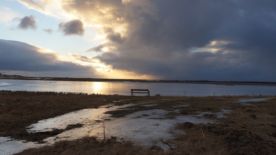 The end of the road in Hofn. The harbour is behind and the sea wall with waves crashing over it on either side of the point.