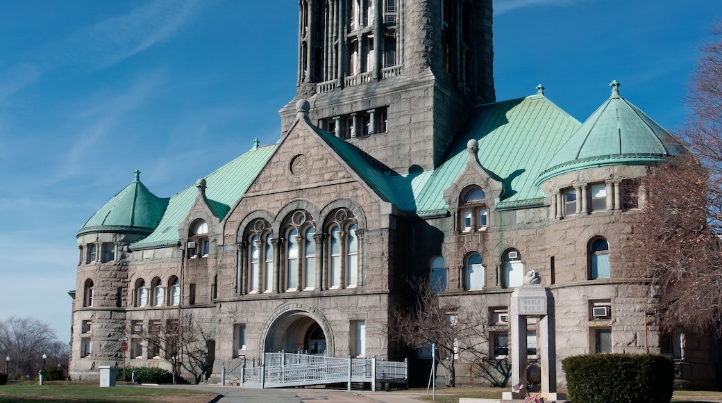 A large stone building with a green dome and arched windows.