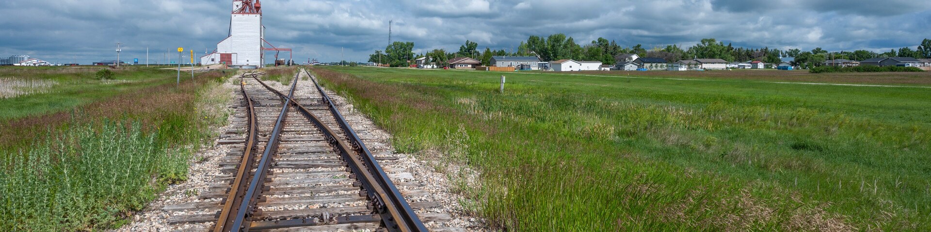 Railway tracks leading to a grain elevator in the village of Francis, Saskatchewan, Canada