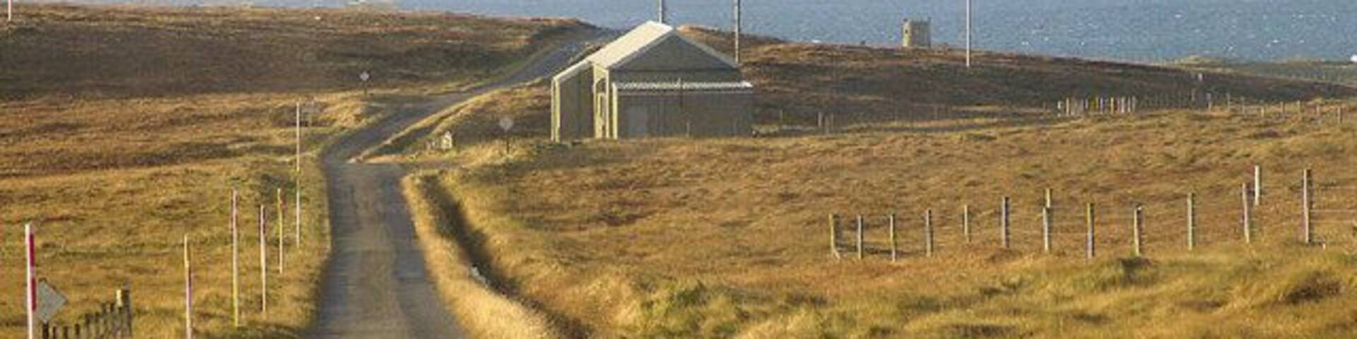 Fetlar Telephone Exchange This is the main road through Fetlar. The tower folly beside Brough Lodge can be seen in the distance.