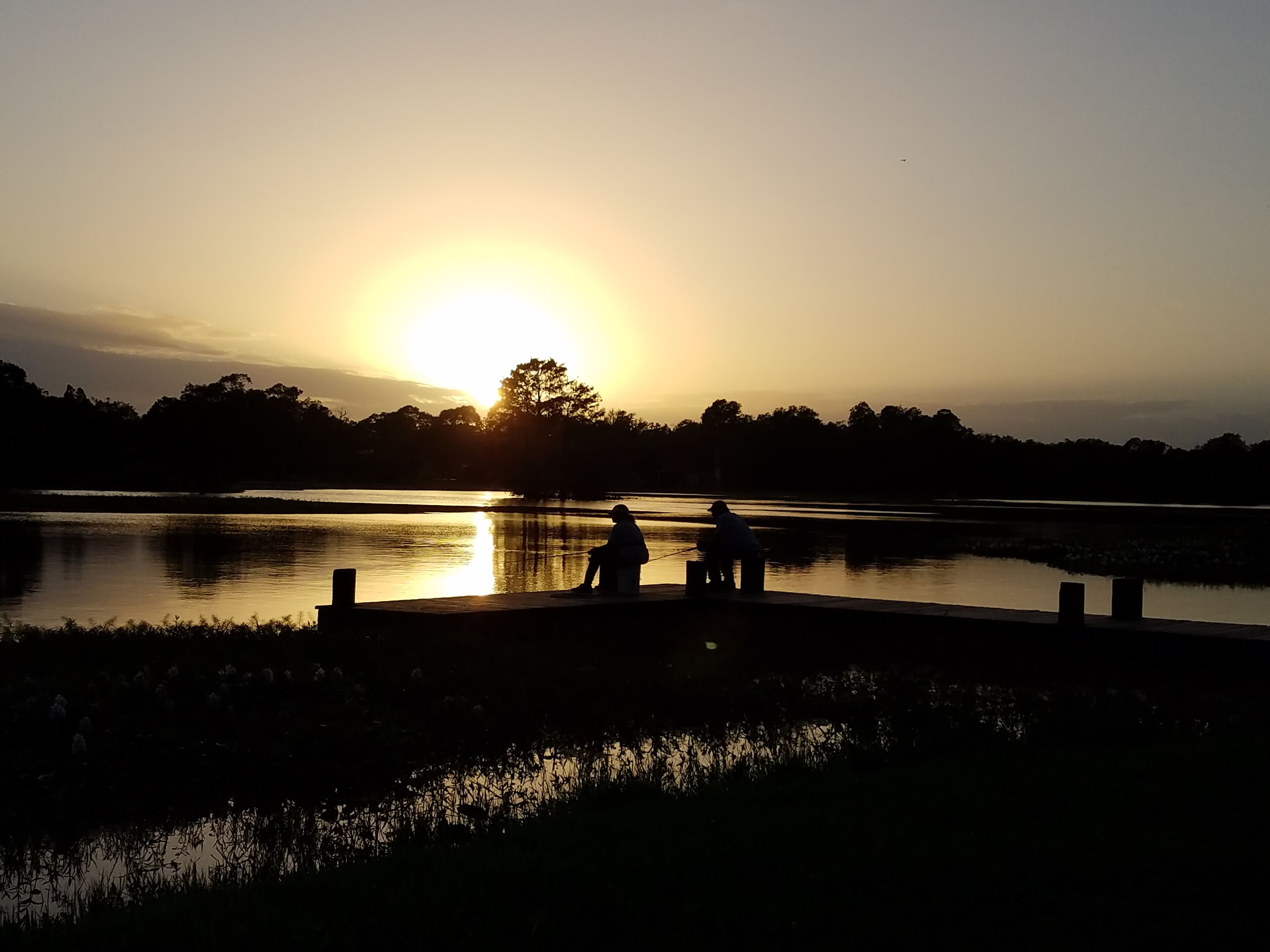 #Trovember 
People were fishing off the ramp during sunset. This is one of my favorite pictures!