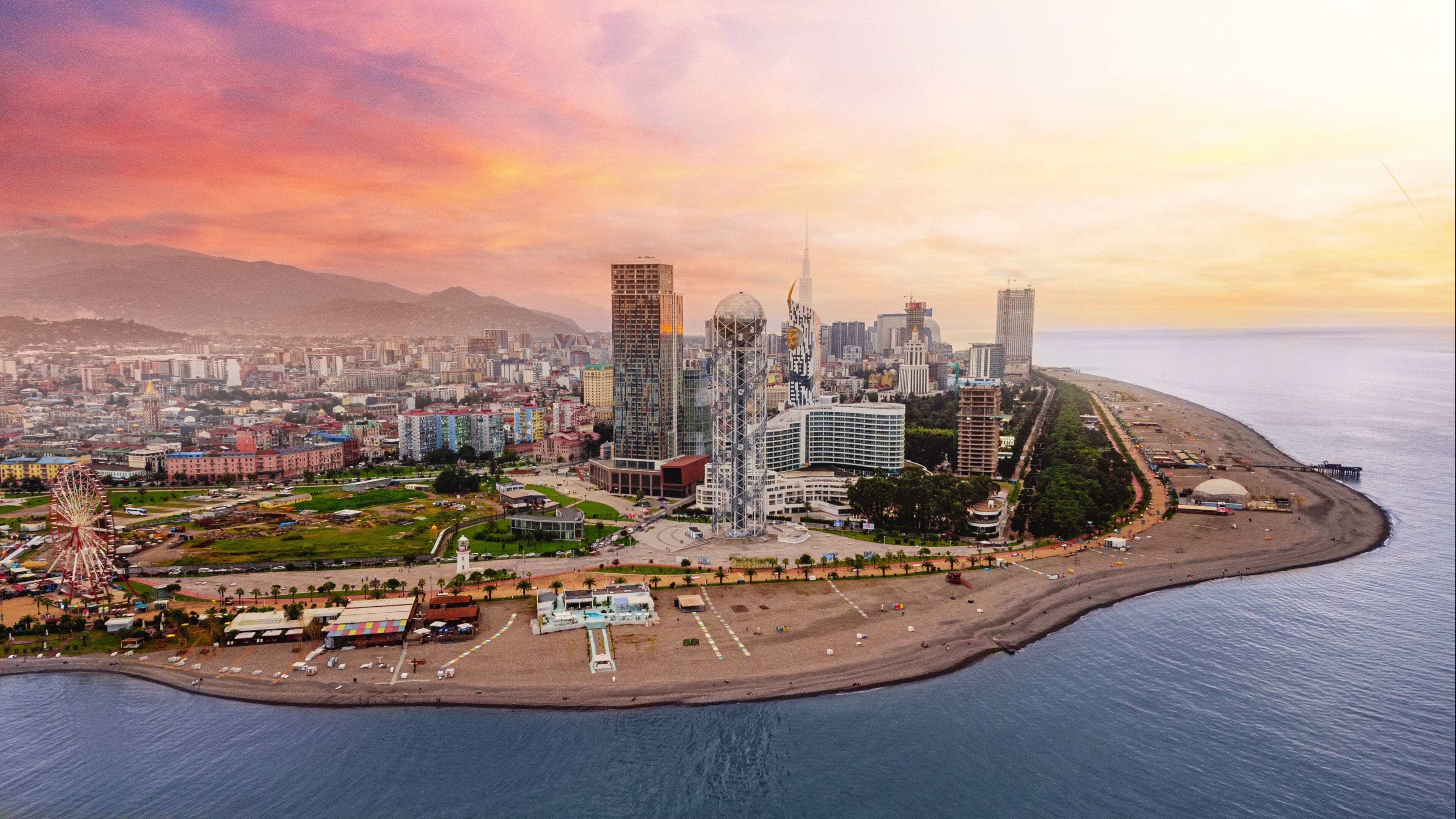 Drone photo of coast Batumi city at pink sunset