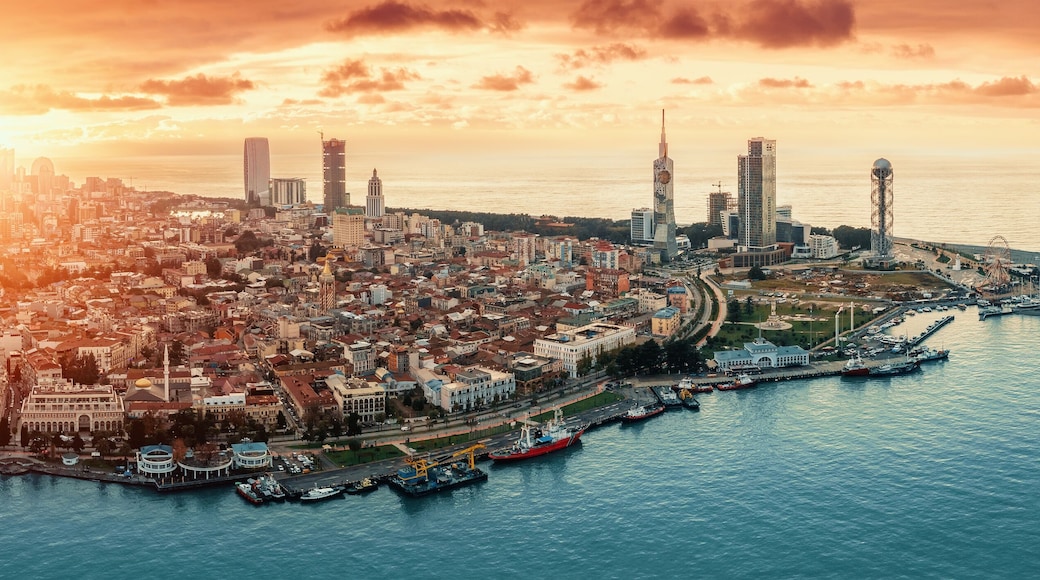 Batumi at sunset, Adjara, Georgia. Aerial panorama view from drone with modern buildings on seafront promenade. Beautiful resort town on Black Sea.