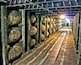 A warehouse with rows of wooden barrels.