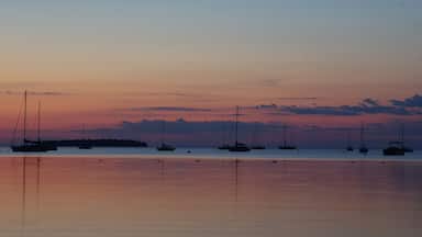 Sunset over lake with sail boats