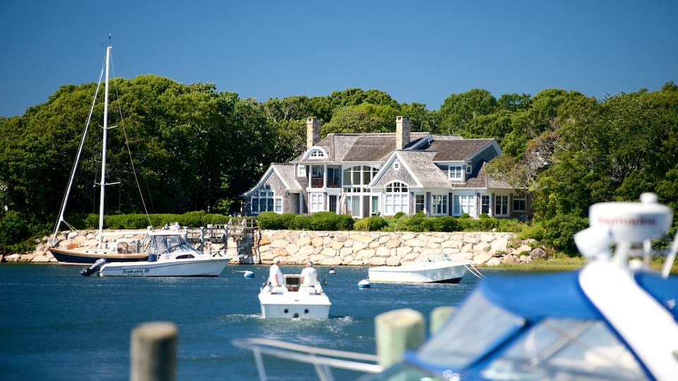 A large house by the water with several boats.