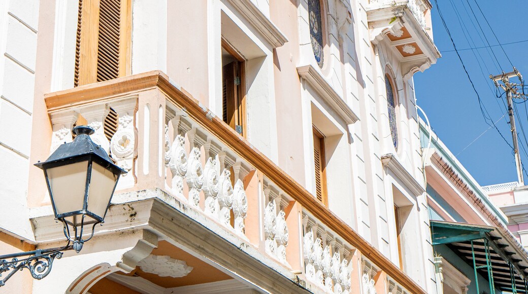 A building with ornate balconies, stained glass windows, and a clear blue sky.