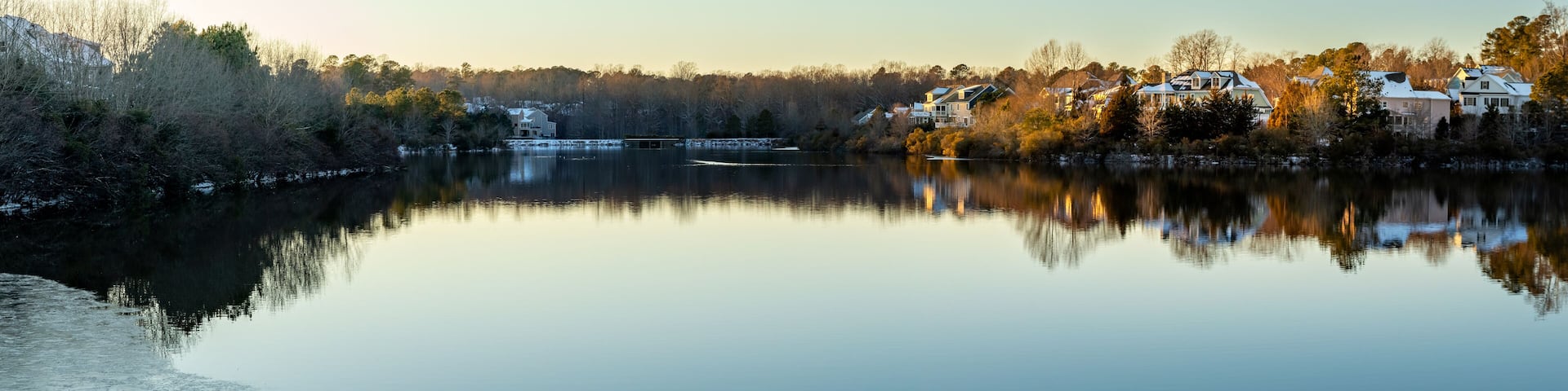 Houses by the Cary Lake Park under golden light sunset on a winter day