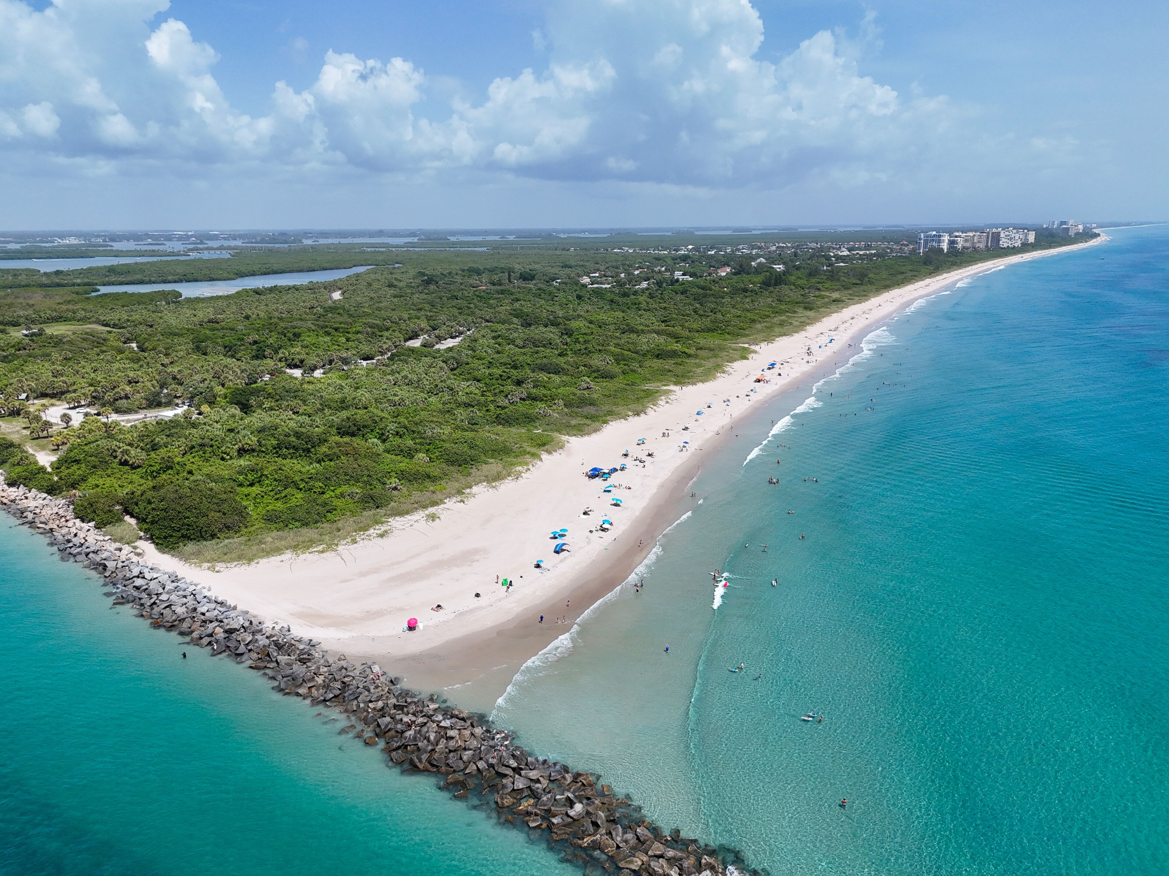 Tourists and locals enjoying a beach day at Fort Pierce Inlet State Park on the Treasure Coast of Florida in St. Lucie County