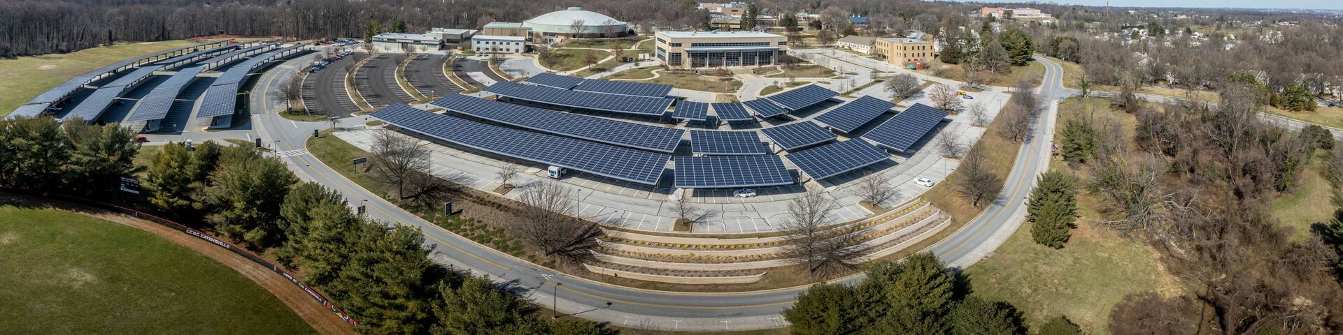 Aerial view of Community College of Baltimore County Catonsville with solar panel covered parking lots, wellness athletic center, continuing education, social science hall, admissions office