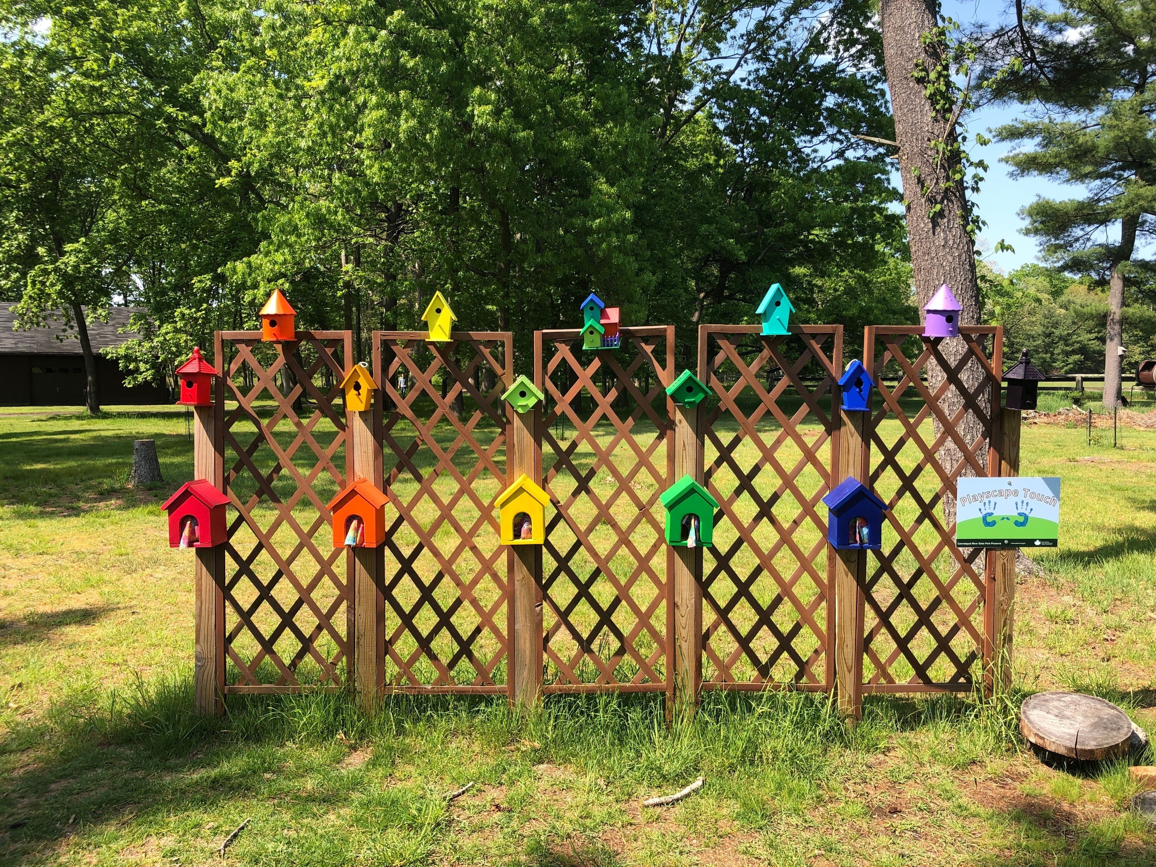 Rainbow colored bird houses at Connetquot River State Park Preserve