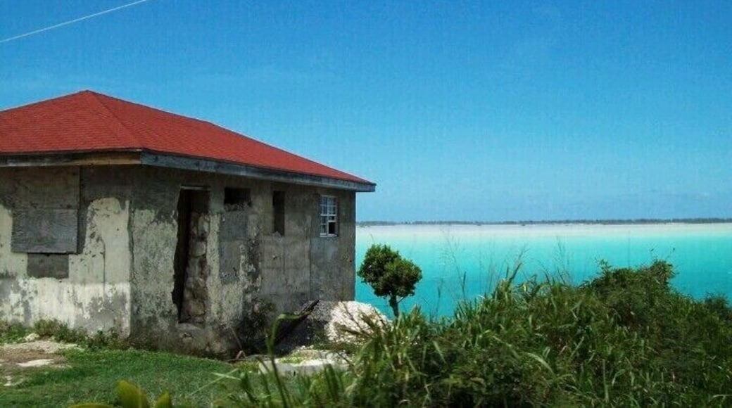On the road in West Caicos, Turks and Caicos Islands. Lots of homes like this pepper the roadsides. A stark contrast to the resorts on Provo, many homes are nothing more than concrete hulls with no electricity or running water. Some of the residents cook in concrete fire pits and do their washing outside as well.