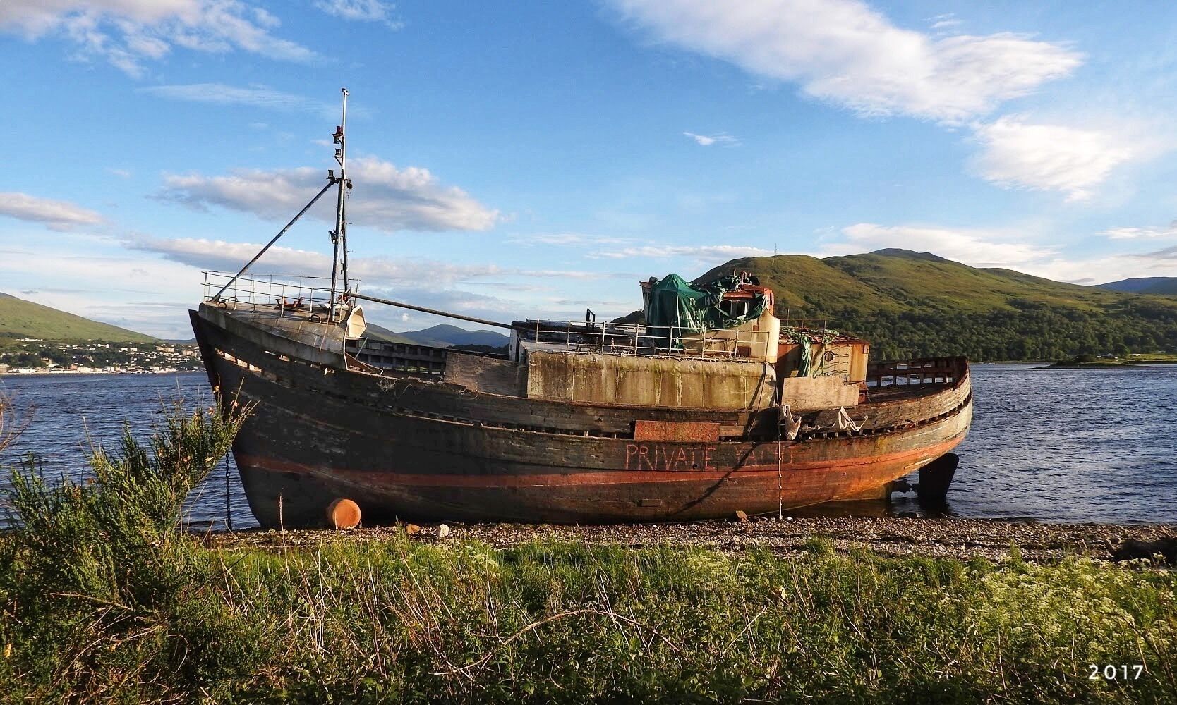 An old ship washed ashore on Loch Linnhe at Fort William on the Higland coast of Scotland.