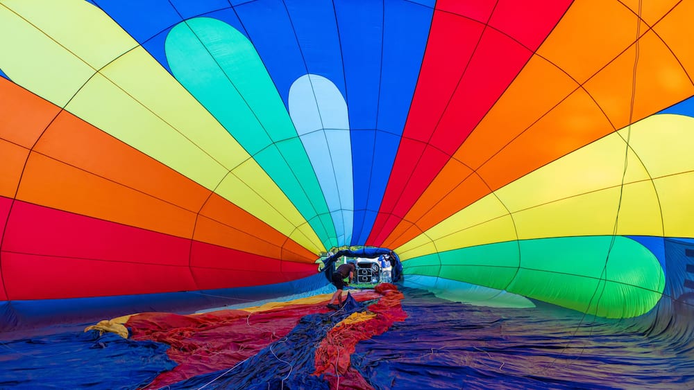 A hot air balloon with a multicolored envelope.
