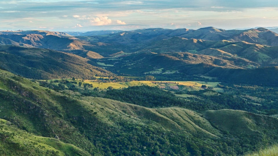 Rolling hills, a valley, and distant mountains.