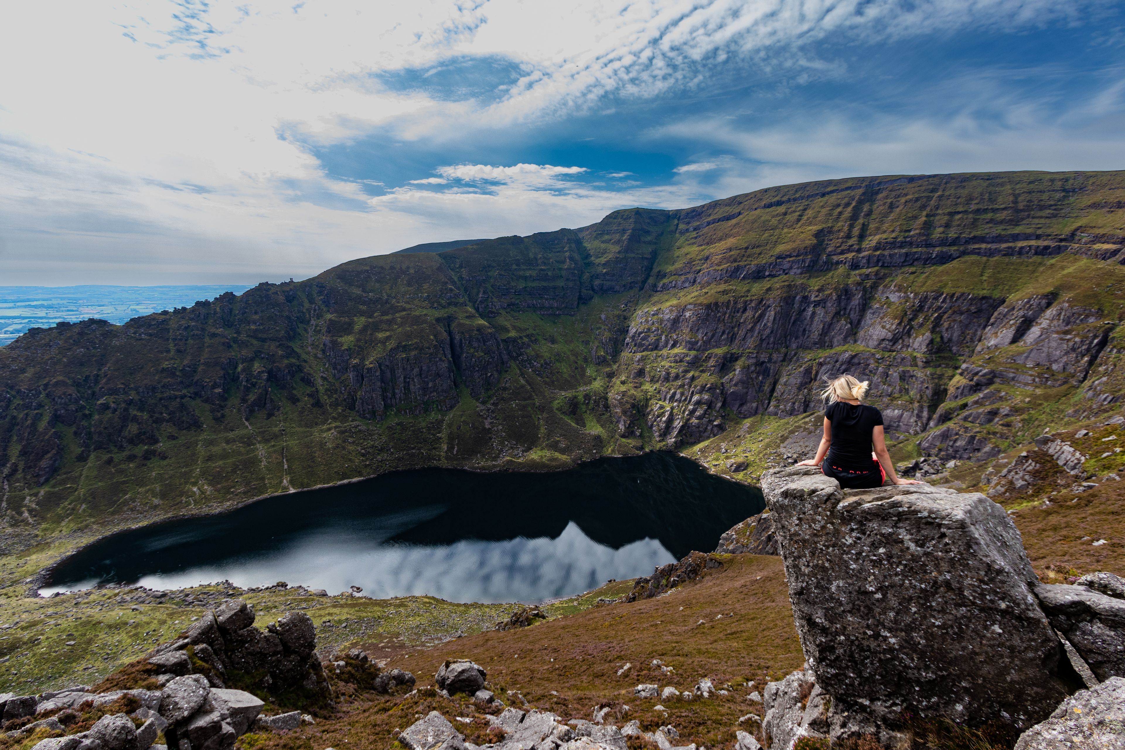 A Caucasian woman from Ireland hiking in Coumshingaun Lough Comeragh Mountains