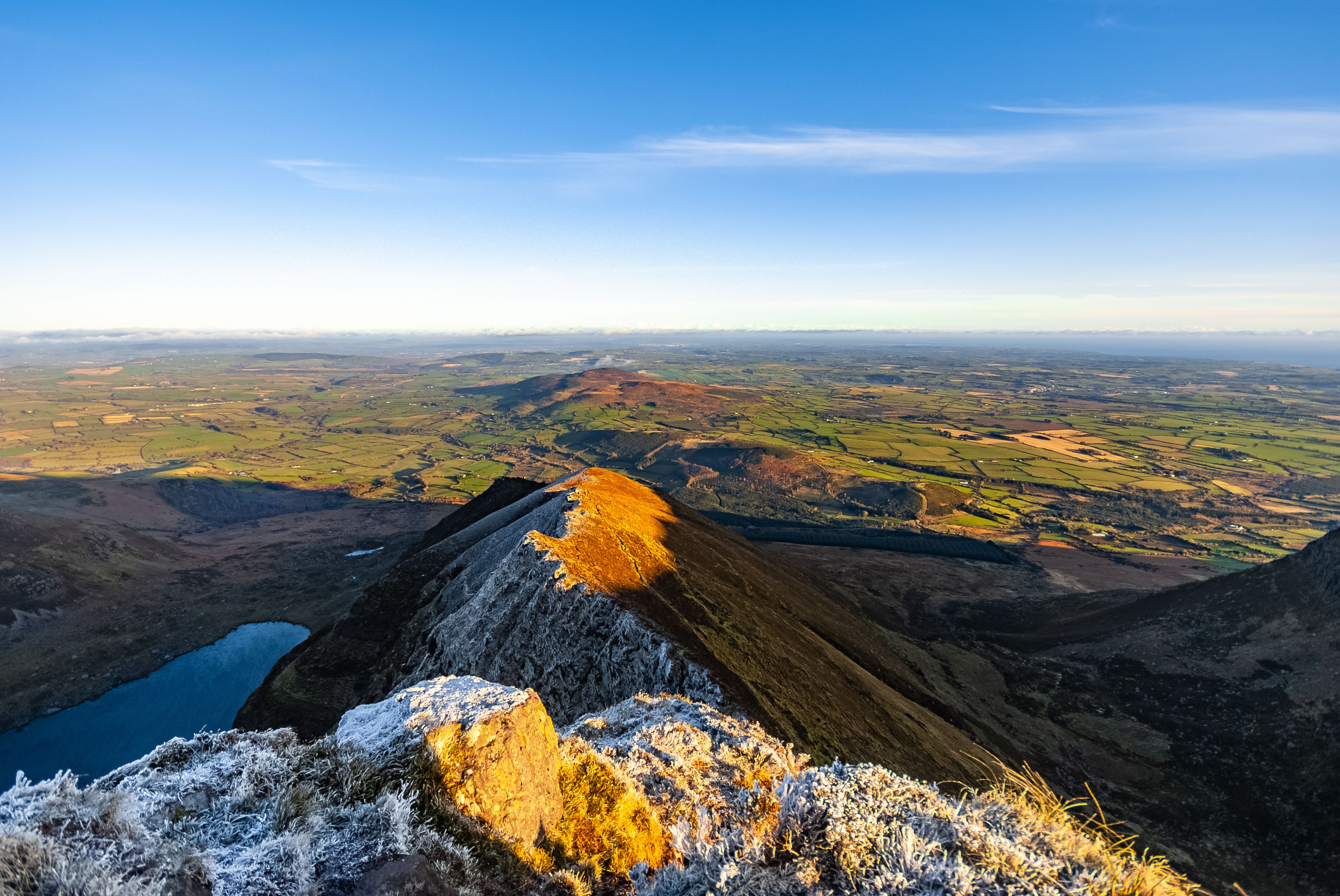 Picturesque Irish landscape with Coumshingaun Lough lake surrounded by Comeragh Mountains in County Waterford, Ireland.