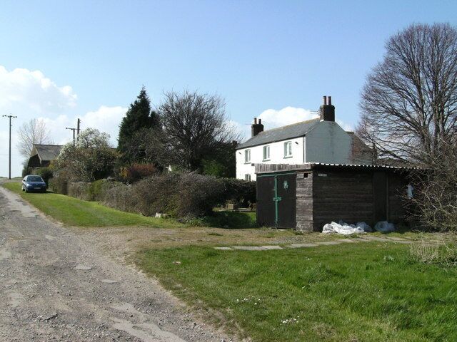 Scrub Holt Farm The rough-looking trackway to the left forms the bridleway to Irby, which climbs for most of its length. Out of sight to the right is a camping/caravanning area.