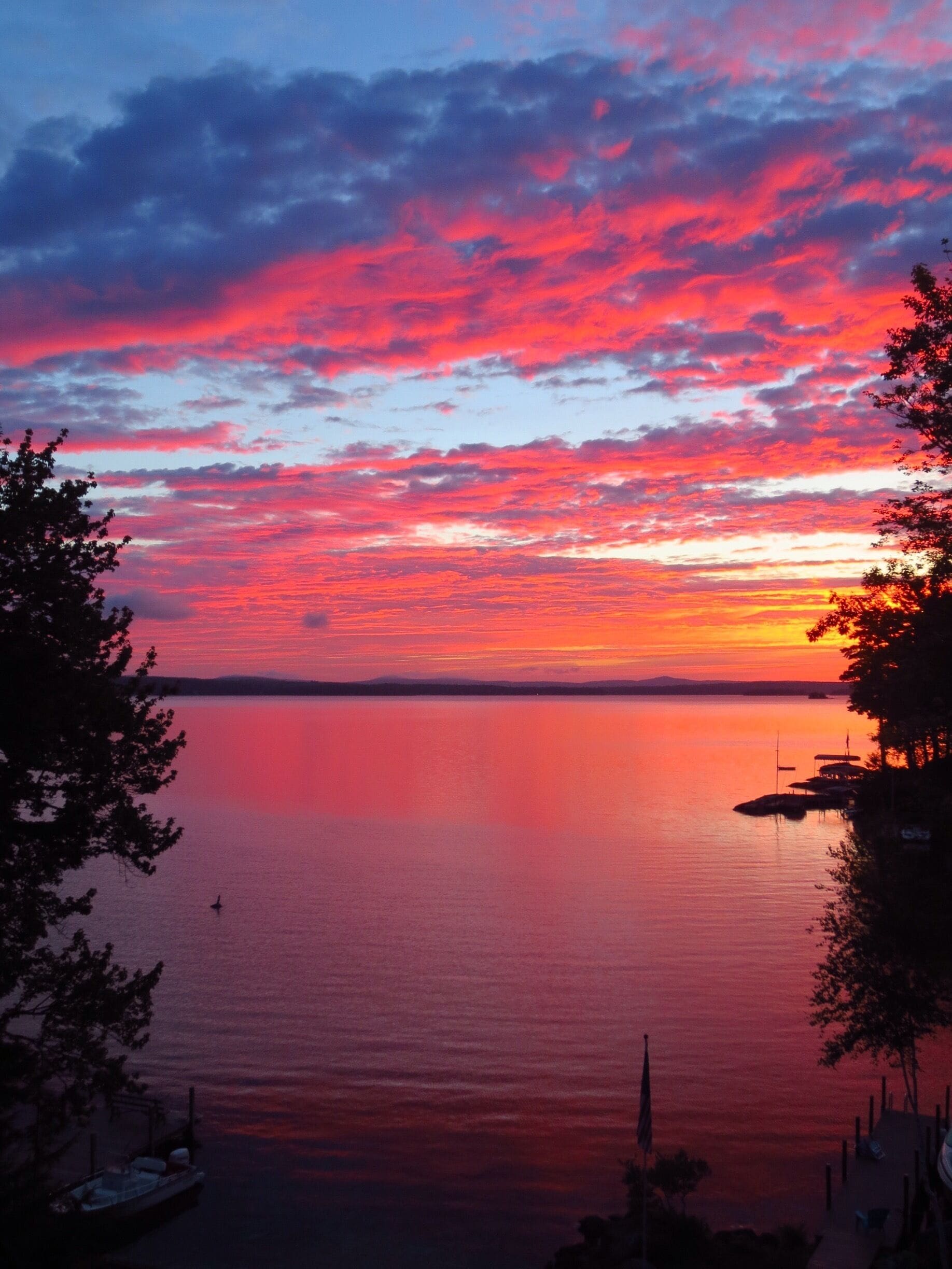 Amazing Late August sunrise from Echo Shores looking east past the tip of Rattlesnake Island toward Wolfboro.