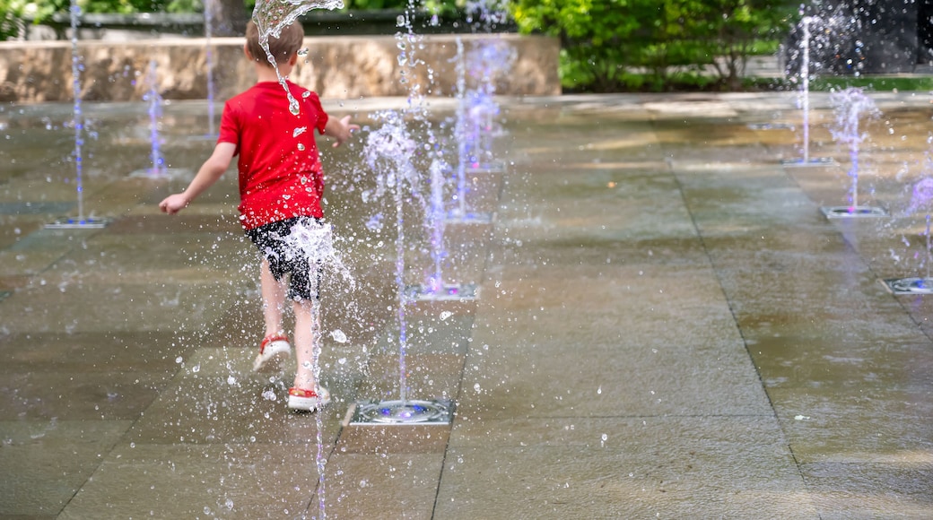 Young boy running through the fountains at the Popup Water Park in St. Louis, Missouri