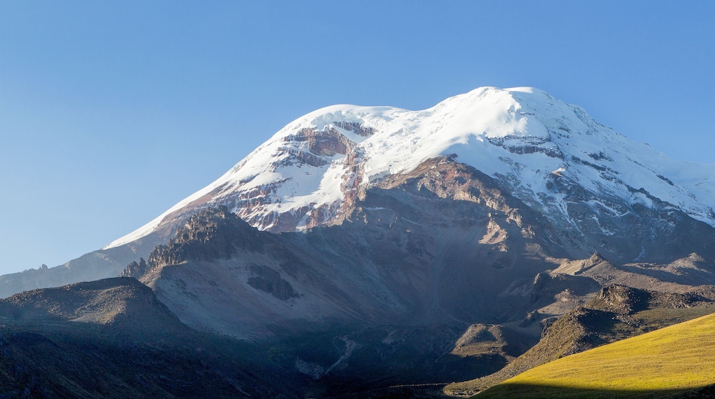 A majestic view of Chimborazo, Ecuador's highest volcano and mountain, with its towering peak surrounded by mist at high altitude.