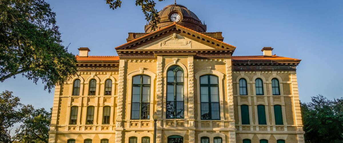 A historic building with a dome and arched windows.