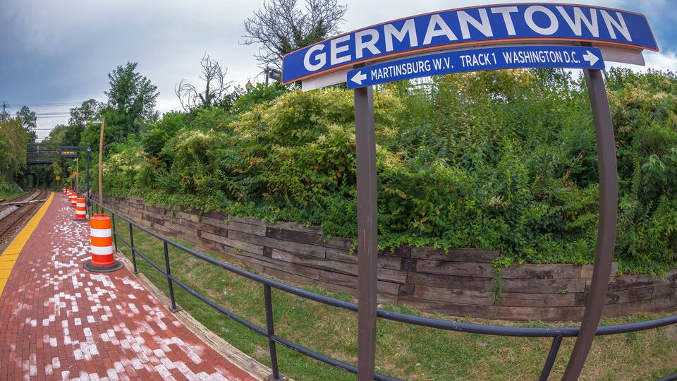 A street sign for Germantown with directional arrows to Washington D.C. and Martinsburg, W.V.