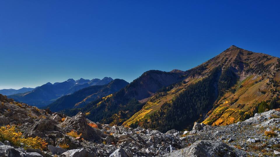 A rugged mountain landscape with rocky terrain and sparse vegetation.