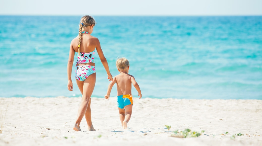 Young girl and boy playing happily at pretty beach