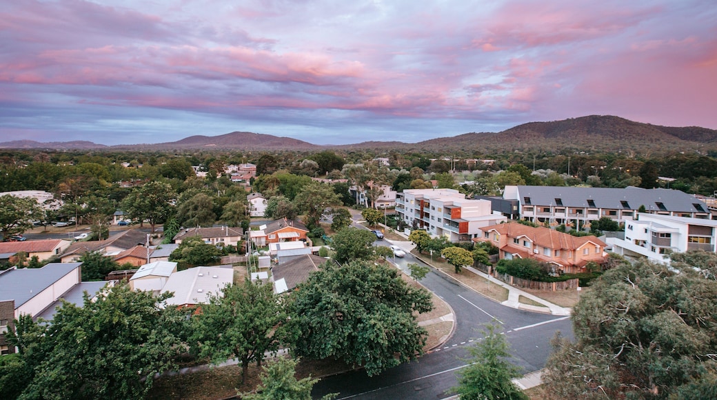 Braddon showing landscape views, a sunset and a small town or village