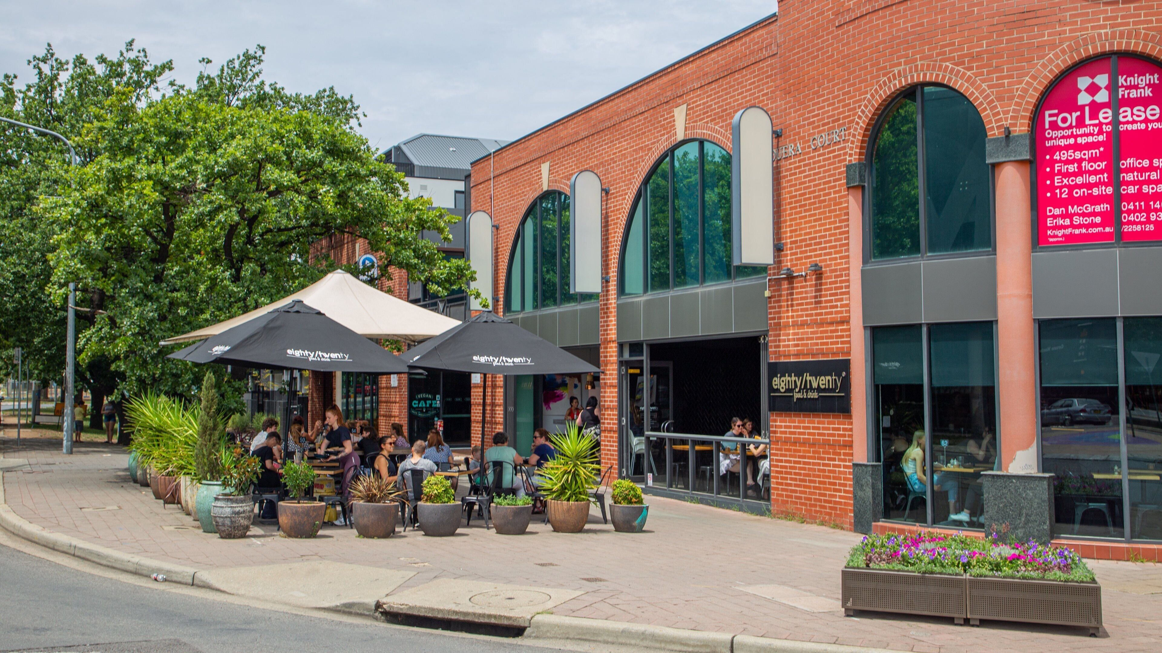Braddon featuring outdoor eating as well as a small group of people