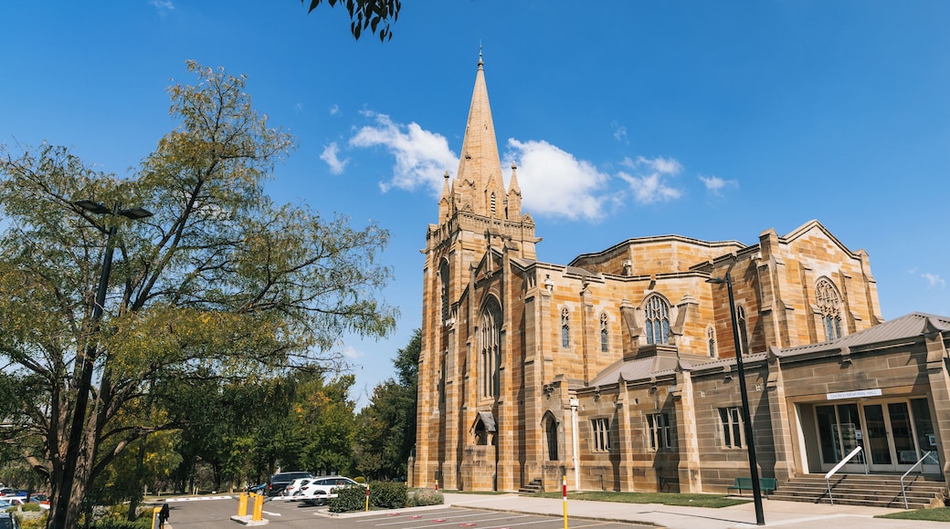 A large church with a tall spire, a stone facade, and a smaller building labeled 'Church Memorial Hall' adjacent to it.