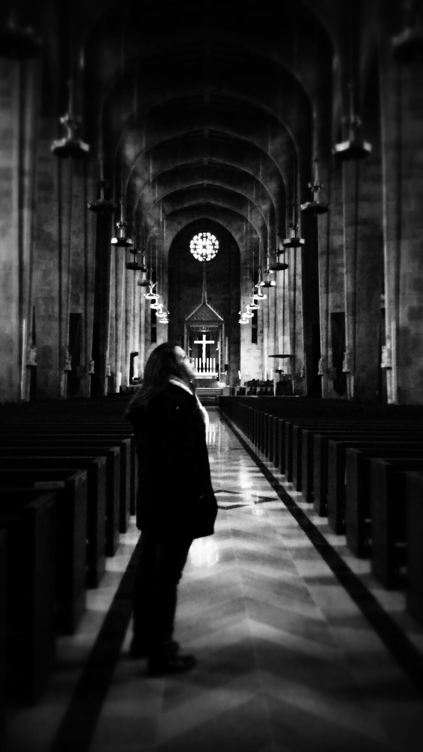 It's difficult not to stand and stare in awe inside the Cathedral of Mary Our Queen. I captured this image of a friend lost in the intricate art of hundreds of stained glass windows lining the cathedral walls.