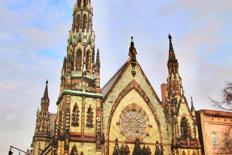 A historic church with a tall spire and intricate architecture.