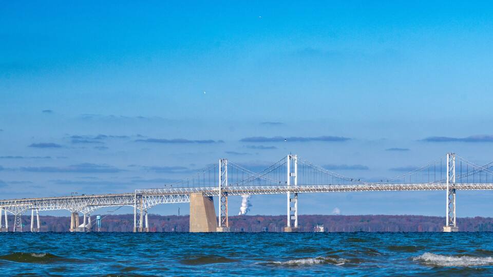 The Chesapeake Bay Bridge under a brilliant blue sky on a crisp autumn day.