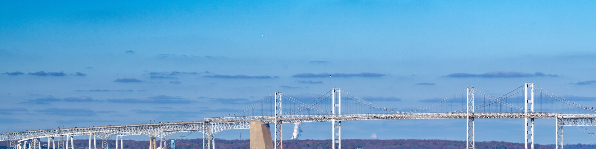The Chesapeake Bay Bridge under a brilliant blue sky on a crisp autumn day.